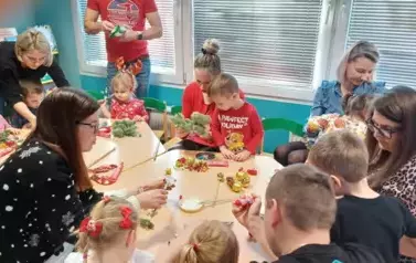 Dzieci wraz z rodzicami wykonują stroik świąteczny