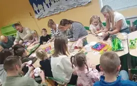 Rodzice z dziećmi wykonują kwiatka