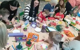 Rodzice z dziećmi wykonują kwiatka
